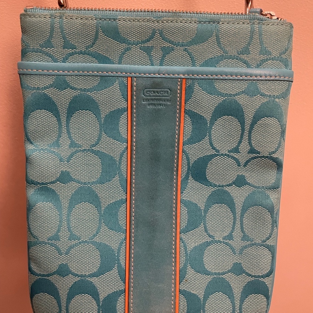 Coach turquoise crossbody with adjustable canvas strap.